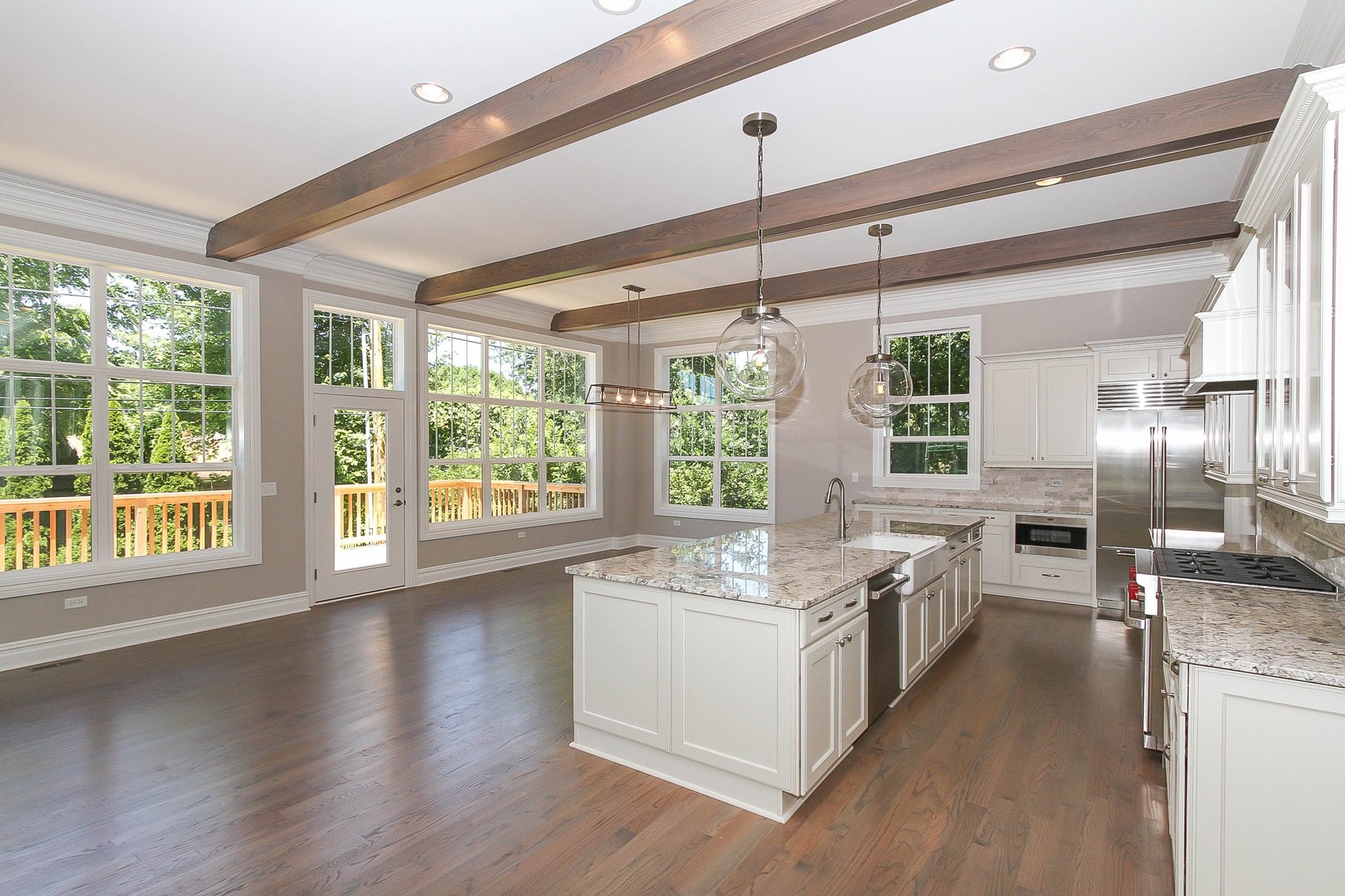 635 North Main Street Naperville, IL 60563 - Photo 17 of 26 a kitchen with stainless steel appliances granite countertop a stove and a large window