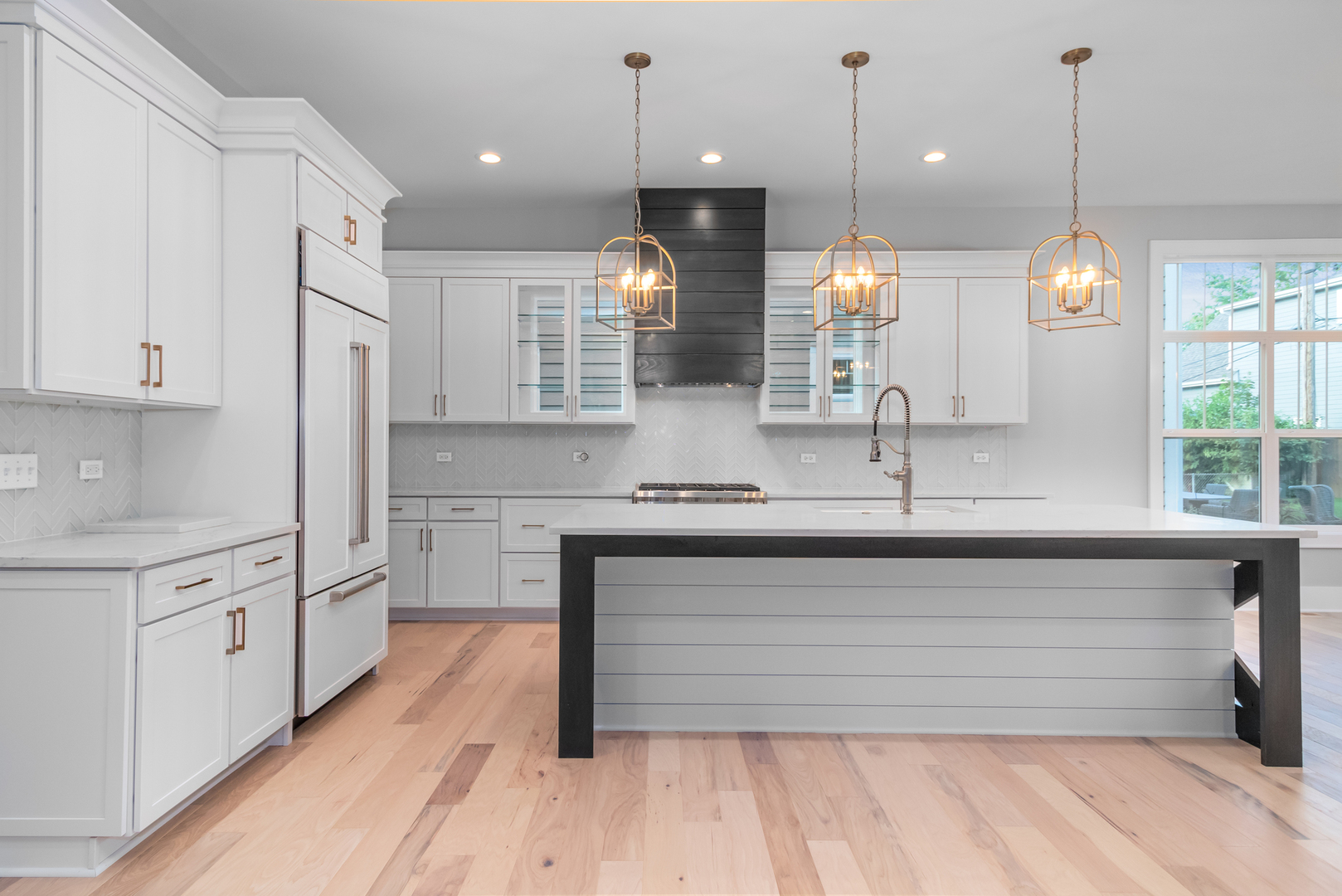 635 North Main Street Naperville, IL 60563 - Photo 21 of 26 a large kitchen with granite countertop a white stove top oven a sink dishwasher a dining table and chairs with wooden floor