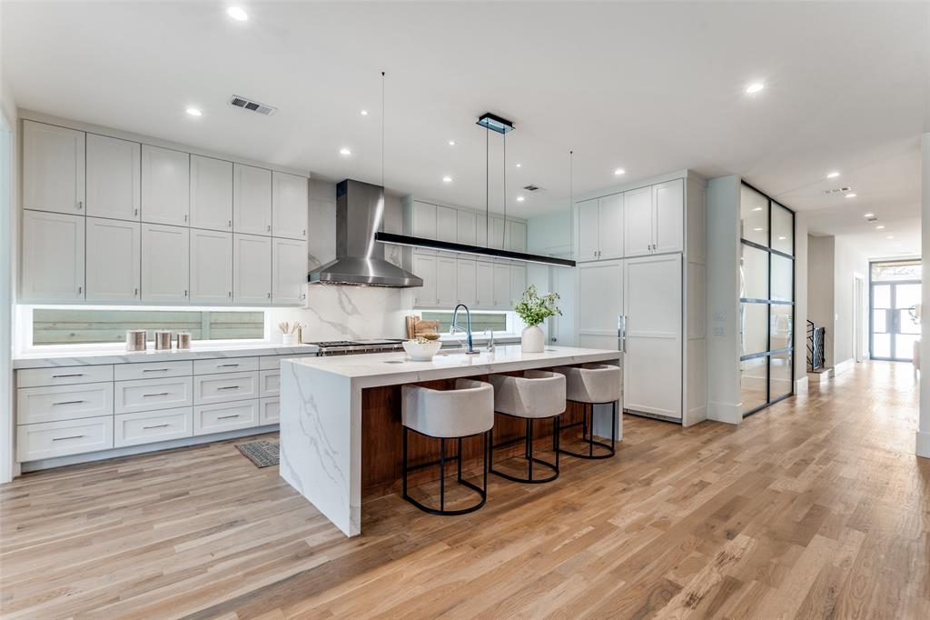 5111 West Amherst Avenue Dallas, TX 75209 - Photo 12 of 36 a kitchen with white cabinets stainless steel appliances and kitchen island