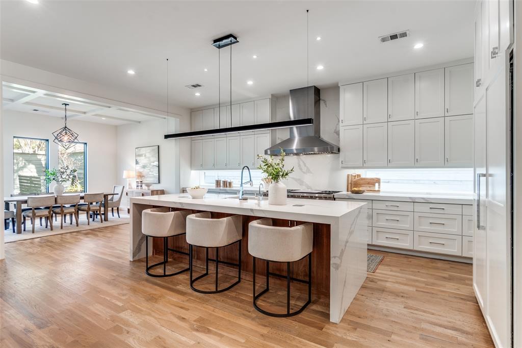 5111 West Amherst Avenue Dallas, TX 75209 - Photo 13 of 36 a kitchen with white cabinets stainless steel appliances and dining table