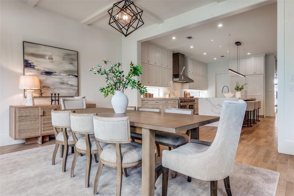 5111 West Amherst Avenue Dallas, TX 75209 - Photo 19 of 36 a dining room with furniture a kitchen and a chandelier
