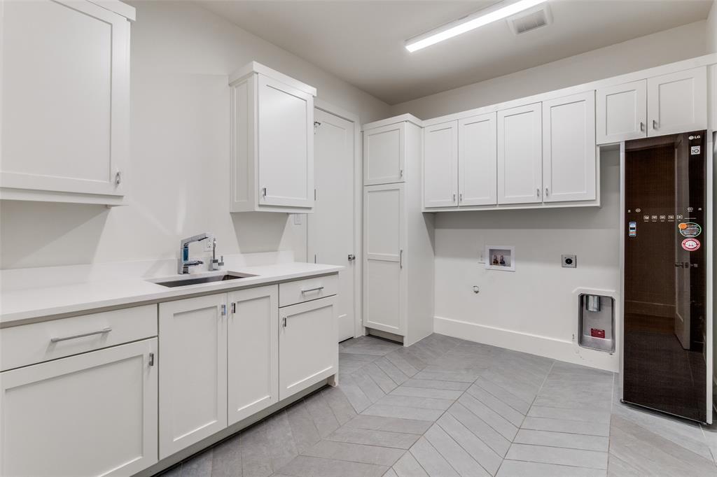 5111 West Amherst Avenue Dallas, TX 75209 - Photo 24 of 36 a kitchen with granite countertop white cabinets and refrigerator