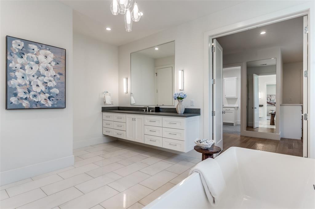 5111 West Amherst Avenue Dallas, TX 75209 - Photo 28 of 36 a spacious bathroom with a double vanity sink a mirror and a bathtub