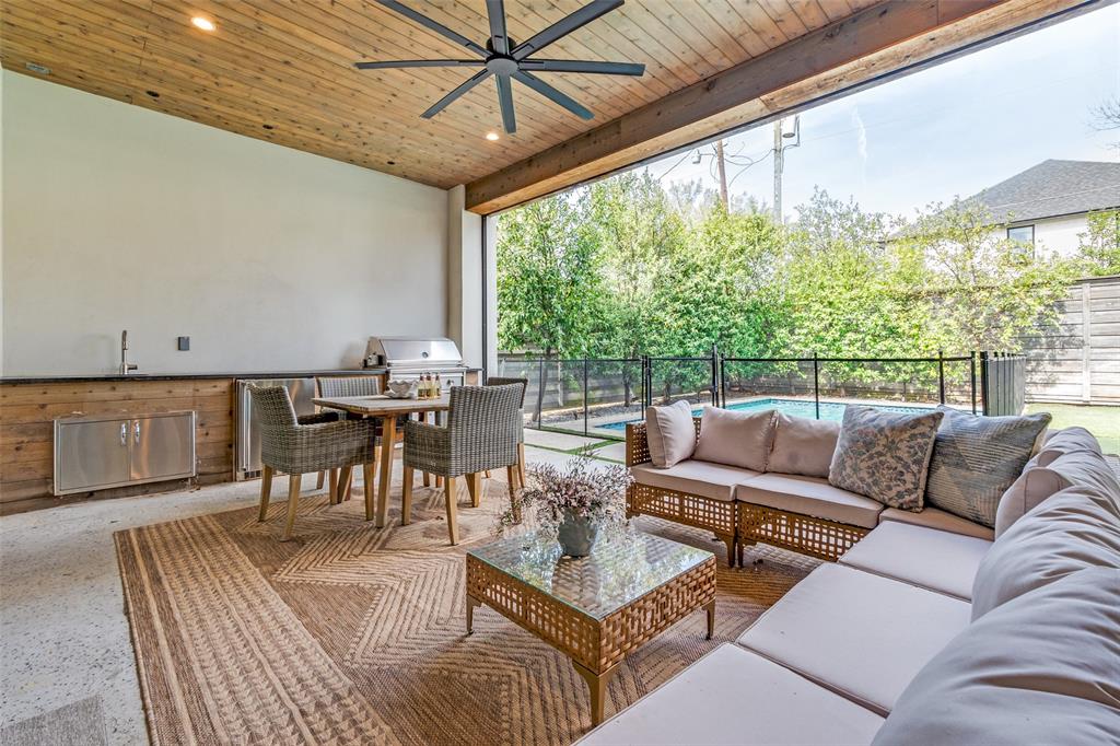 5111 West Amherst Avenue Dallas, TX 75209 - Photo 32 of 36 a living room with furniture a large window and a table