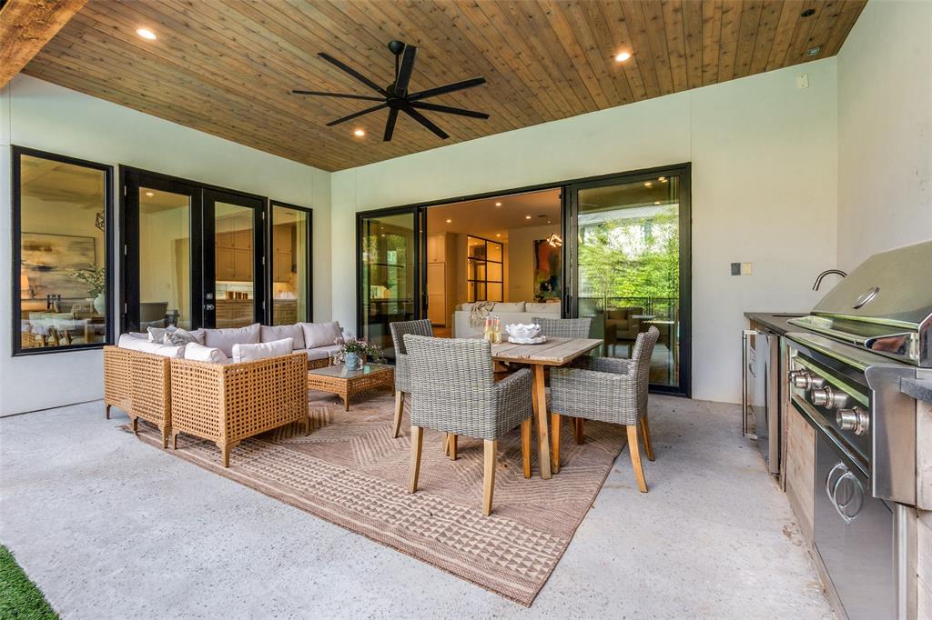 5111 West Amherst Avenue Dallas, TX 75209 - Photo 34 of 36 a dining room with furniture a flat screen tv and a chandelier