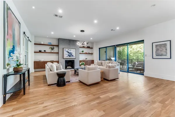 a living room with fireplace furniture and a wooden floor