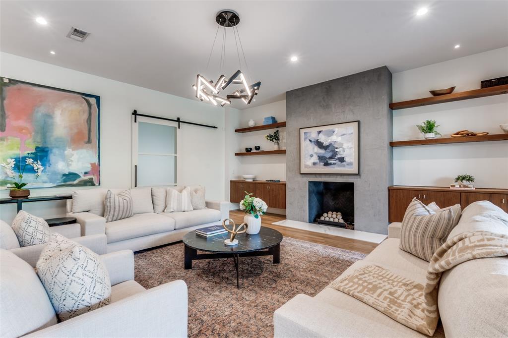 5111 West Amherst Avenue Dallas, TX 75209 - Photo 7 of 36 a living room with furniture a fireplace and a large mirror