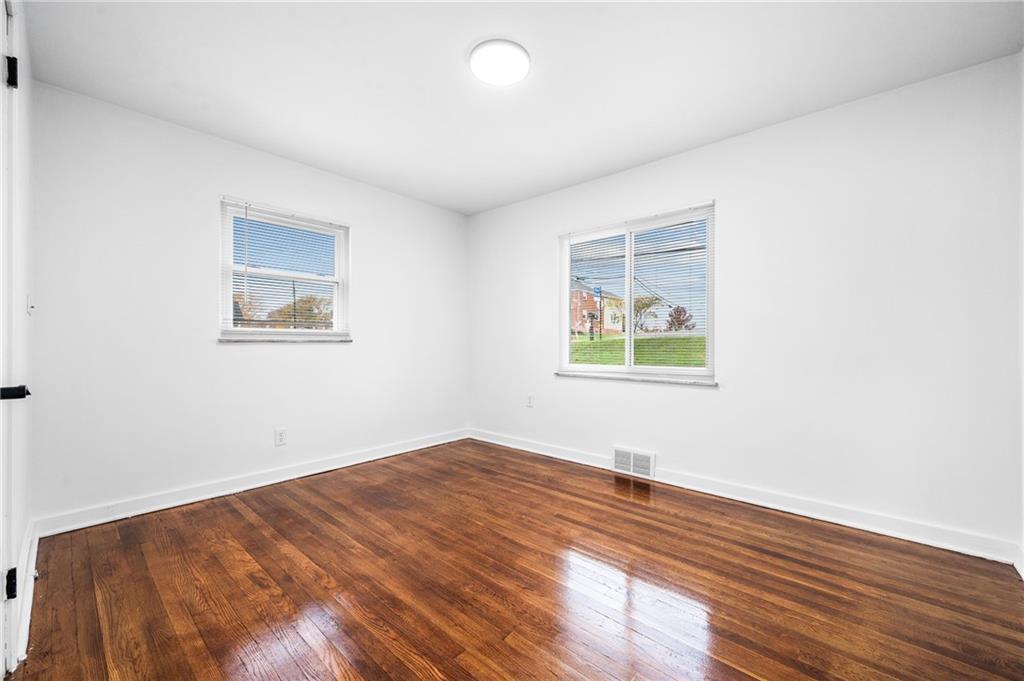 63 Herbst Road Coraopolis, PA 15108 - Photo 11 of 19 an empty room with wooden floor and windows
