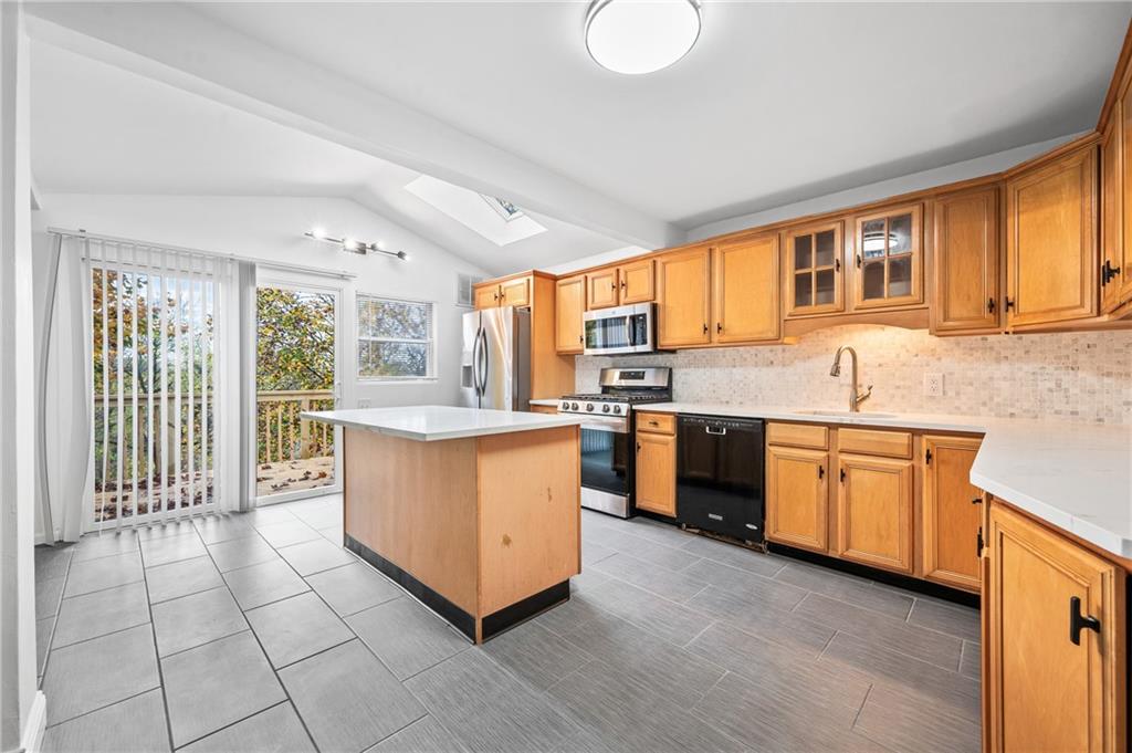 63 Herbst Road Coraopolis, PA 15108 - Photo 6 of 19 a kitchen with stainless steel appliances granite countertop a stove a sink and a refrigerator