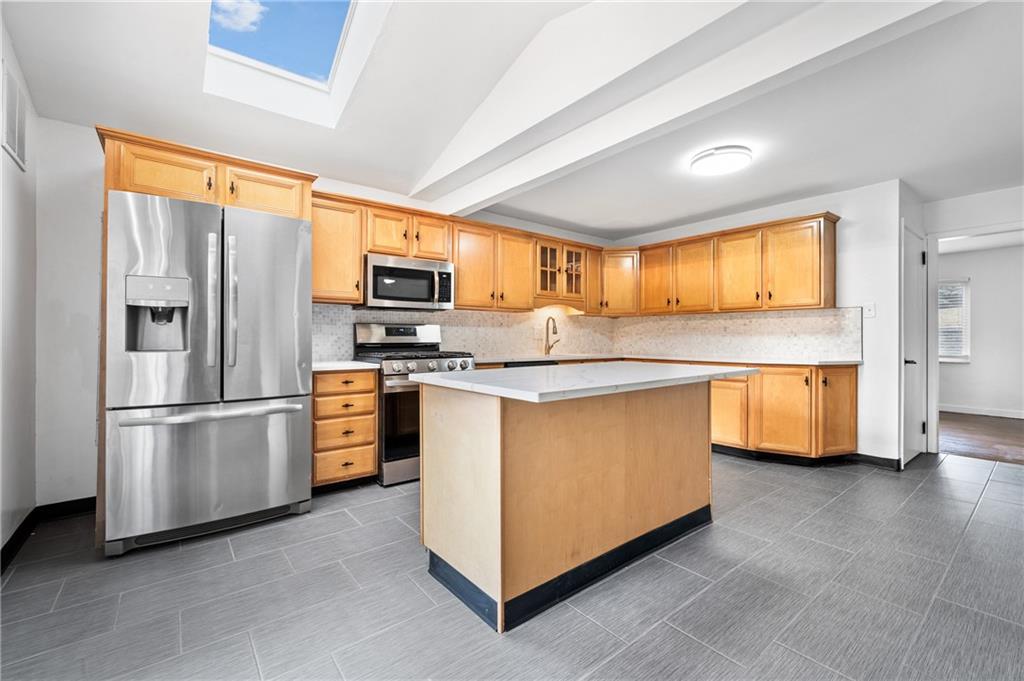 63 Herbst Road Coraopolis, PA 15108 - Photo 7 of 19 a kitchen with stainless steel appliances granite countertop a refrigerator a stove a sink and a microwave