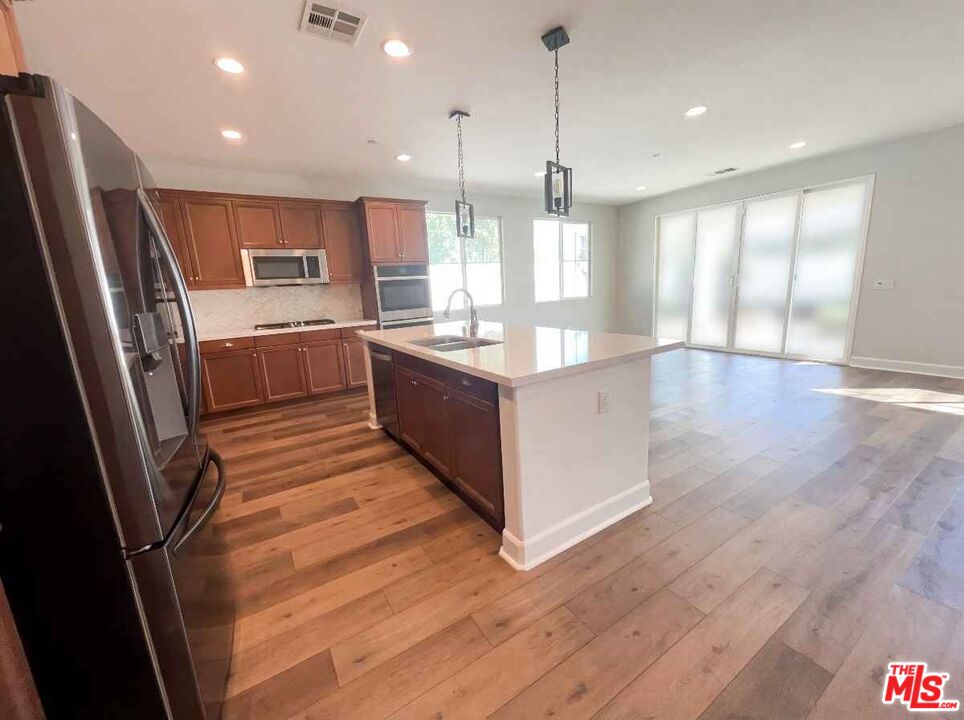 264 Rose Street Fillmore, CA 93015 - Photo 13 of 24 a kitchen with stainless steel appliances granite countertop a refrigerator a sink and a stove