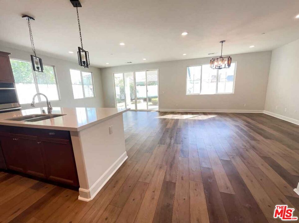 264 Rose Street Fillmore, CA 93015 - Photo 14 of 24 a kitchen with stainless steel appliances granite countertop wooden floors sink and window
