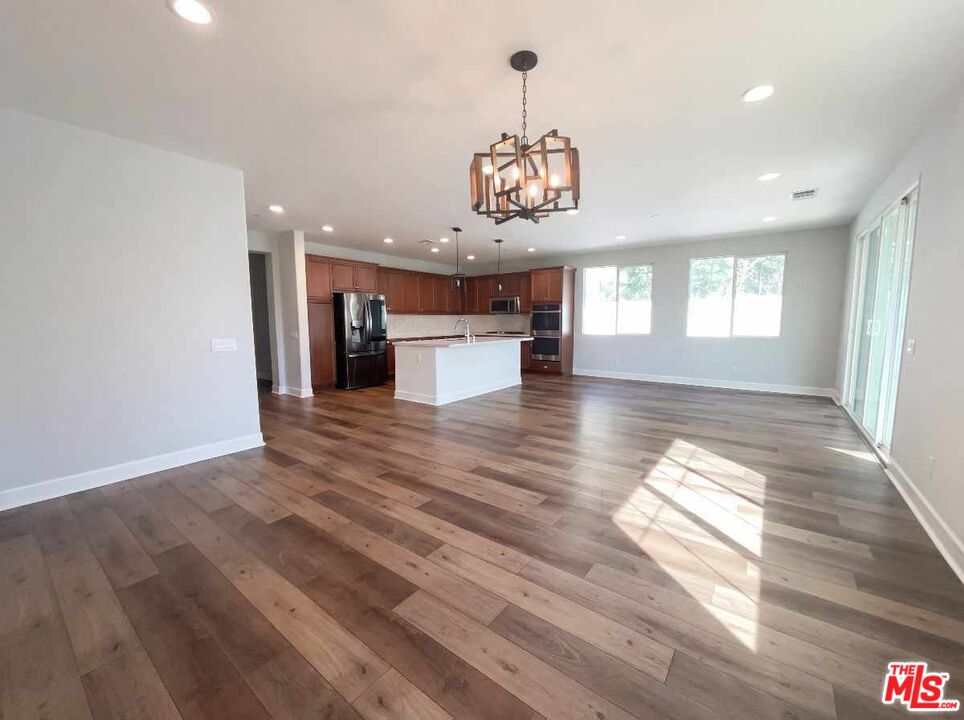 264 Rose Street Fillmore, CA 93015 - Photo 15 of 24 an empty room with wooden floor chandelier and windows