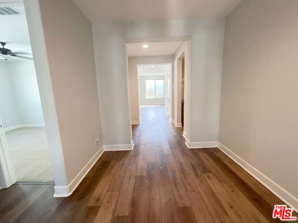 264 Rose Street Fillmore, CA 93015 - Photo 6 of 24 a view of a hallway with wooden floor