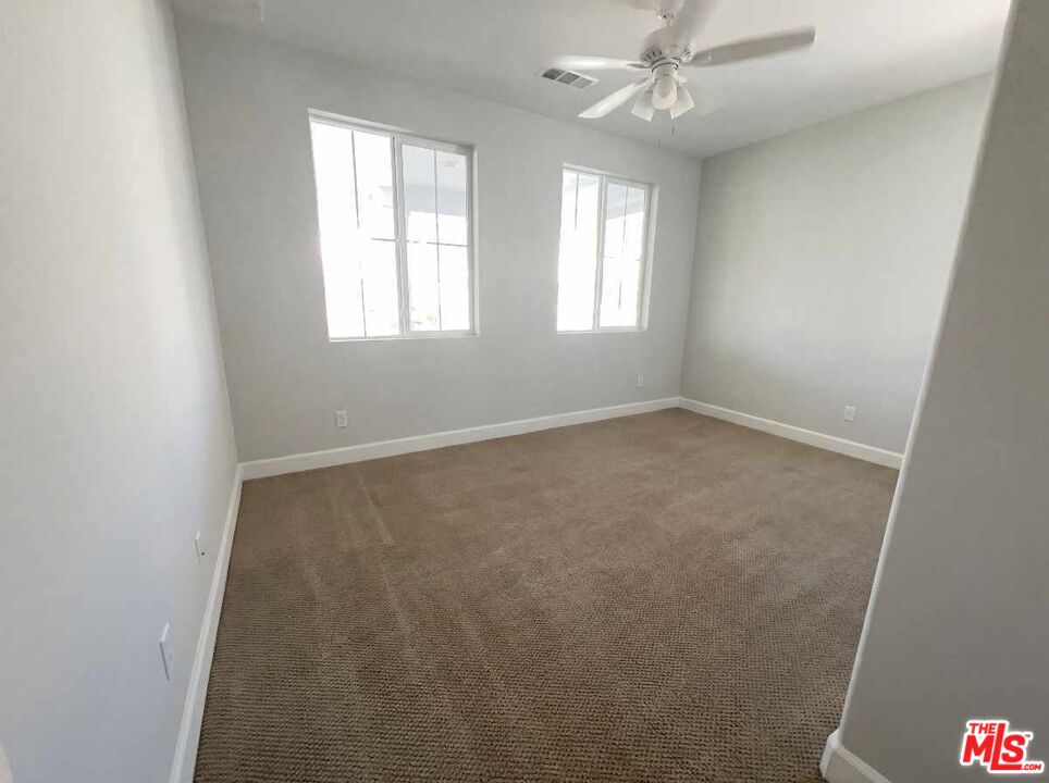 264 Rose Street Fillmore, CA 93015 - Photo 8 of 24 an empty room with windows and fan