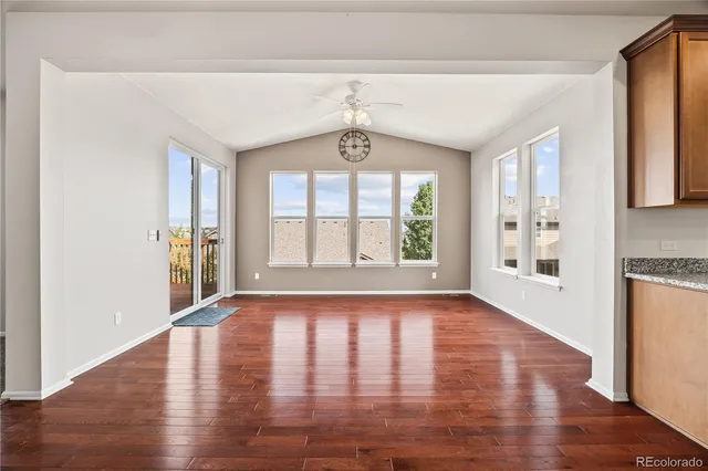 an empty room with fan and windows
