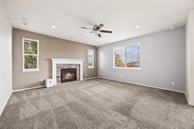 a bathroom with a sink a toilet a mirror and a window