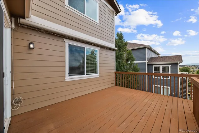 a view of a house with a wooden deck