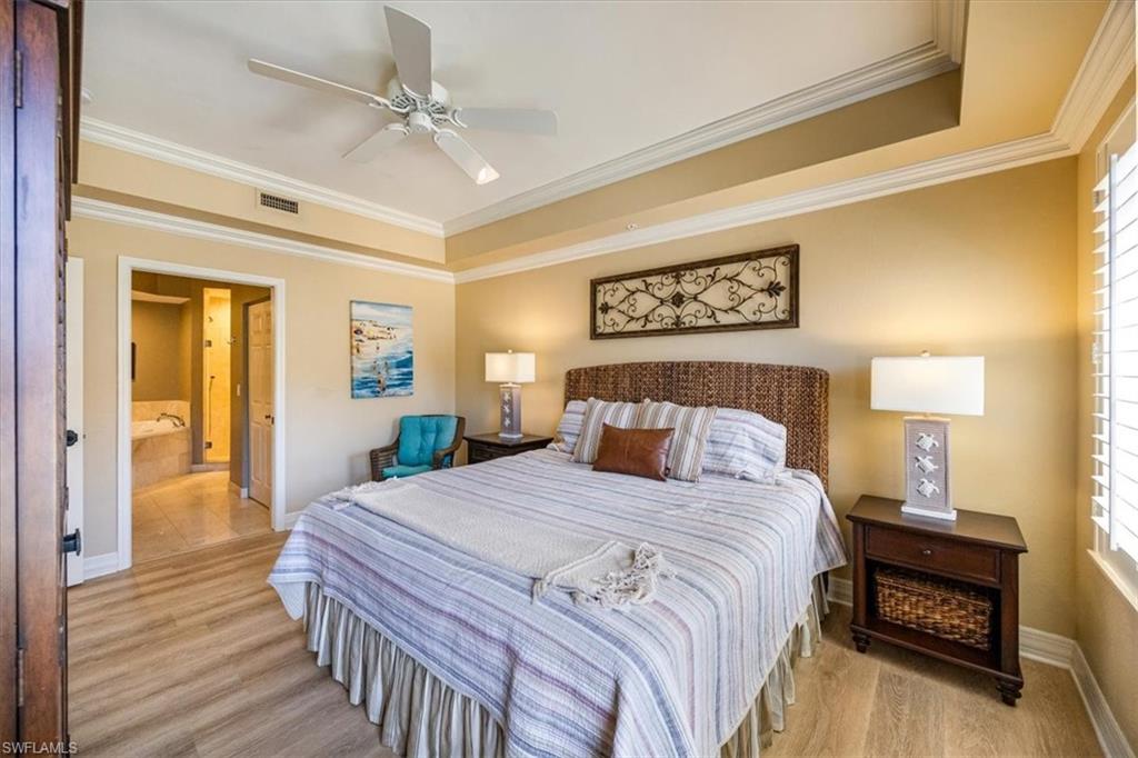 410 Bayfront Place, Unit 2407 Naples, FL 34102 - Photo 11 of 30 a bedroom with a bed and a table
