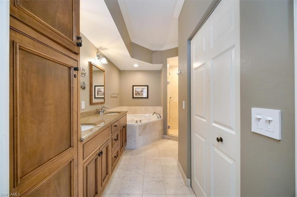 410 Bayfront Place, Unit 2407 Naples, FL 34102 - Photo 12 of 30 a bathroom with a granite countertop tub shower and sink