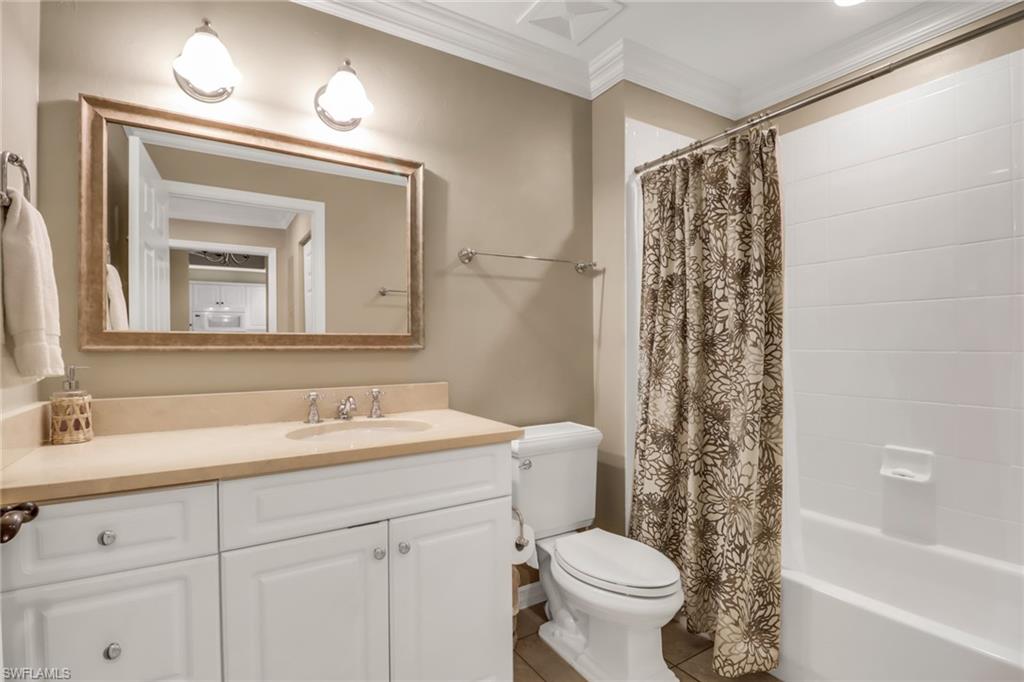 410 Bayfront Place, Unit 2407 Naples, FL 34102 - Photo 15 of 30 a bathroom with a sink a toilet and a mirror