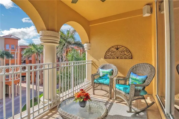 a view of a chairs and table in the balcony