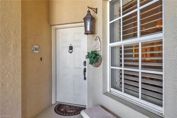 a view of entryway with a shower and wooden door