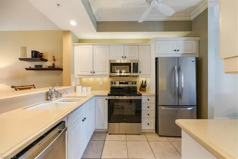 a kitchen with a sink stainless steel appliances and cabinets