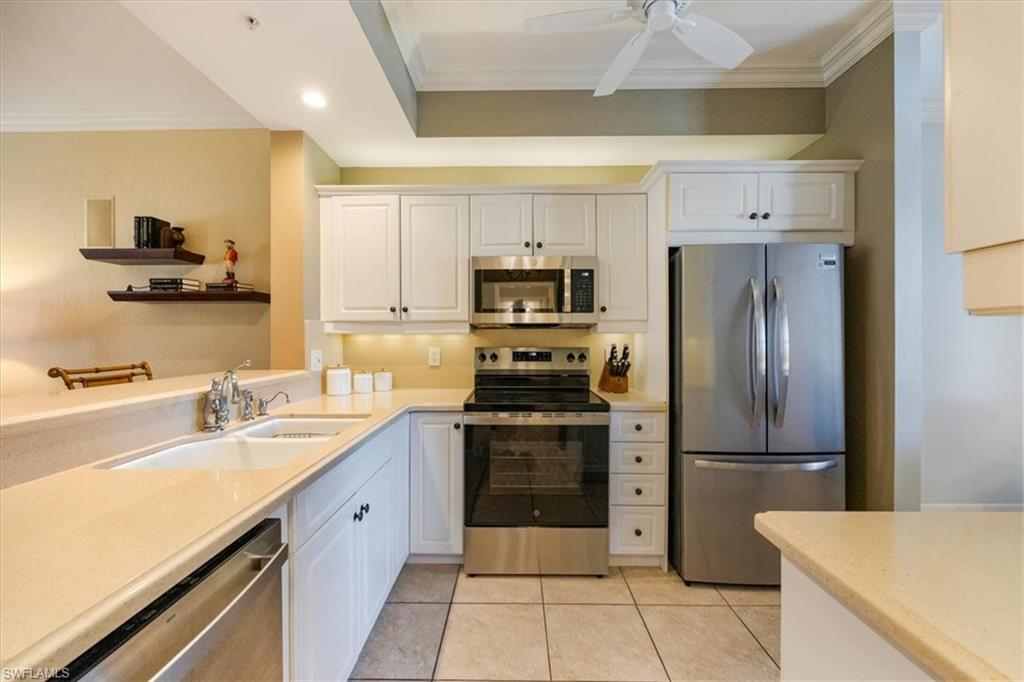 410 Bayfront Place, Unit 2407 Naples, FL 34102 - Photo 7 of 30 a kitchen with a sink stainless steel appliances and cabinets