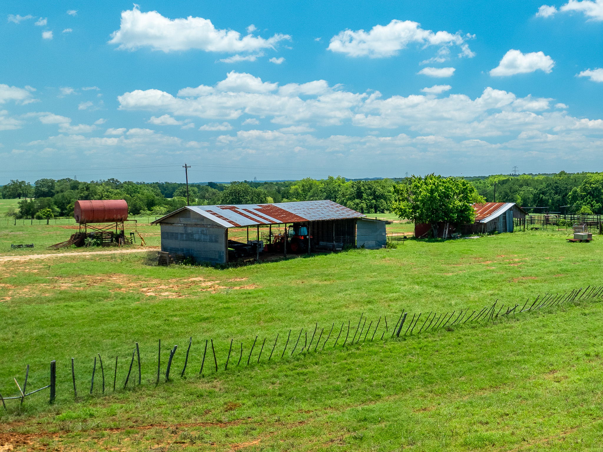400 619th Spur Elgin, TX 78621 - Photo 37 of 40 Green pastures with farm buildings and lush trees await your next rural venture.