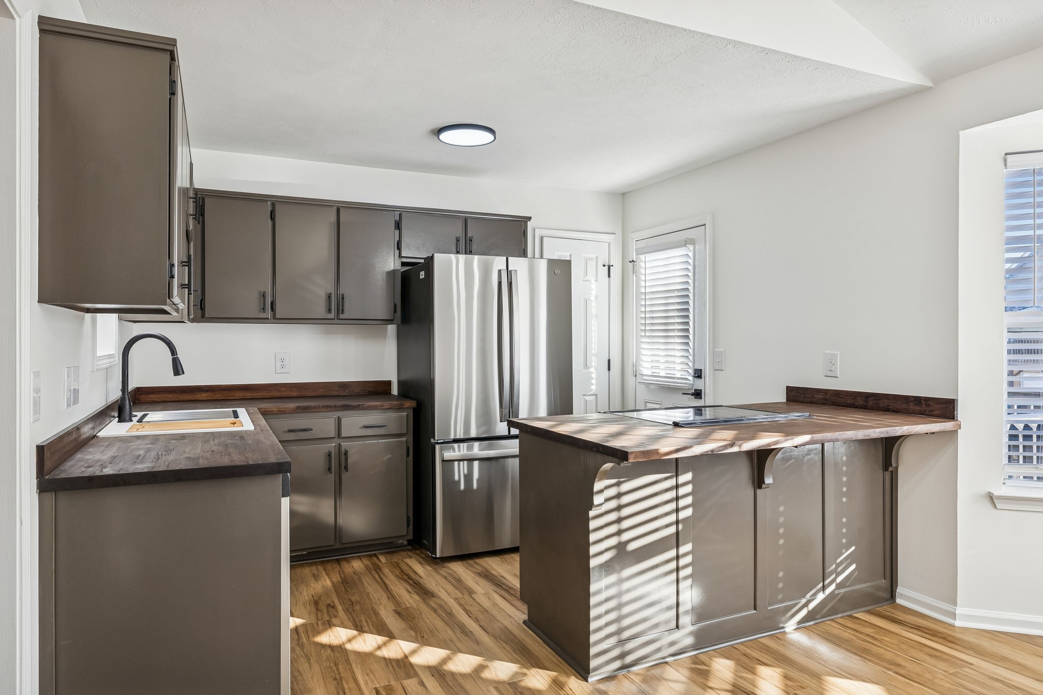803 Pebble Point Mount Juliet, TN 37122 - Photo 13 of 39 a kitchen with stainless steel appliances granite countertop a sink stove and refrigerator