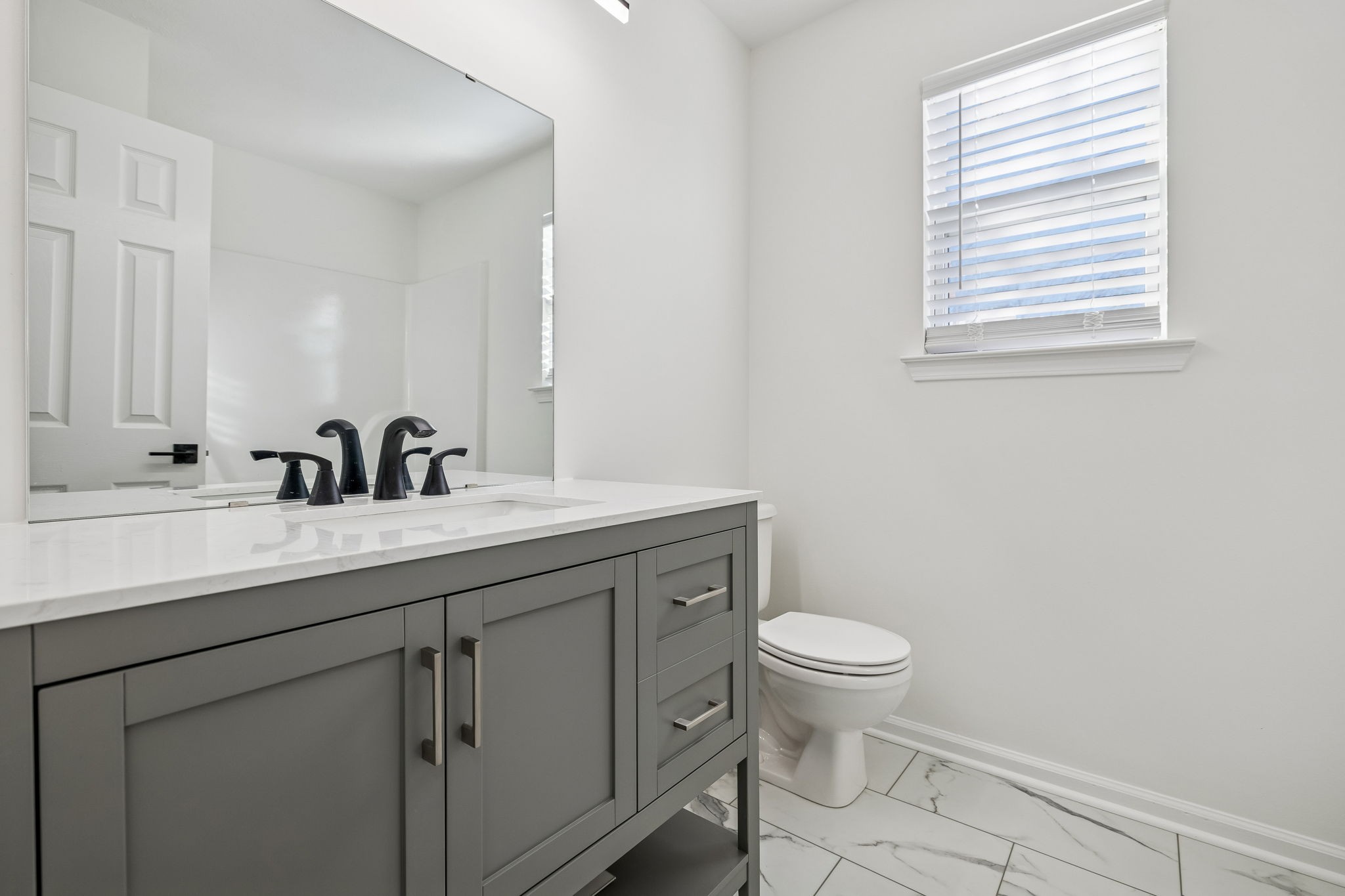 803 Pebble Point Mount Juliet, TN 37122 - Photo 29 of 39 a bathroom with a granite countertop sink a toilet and a mirror