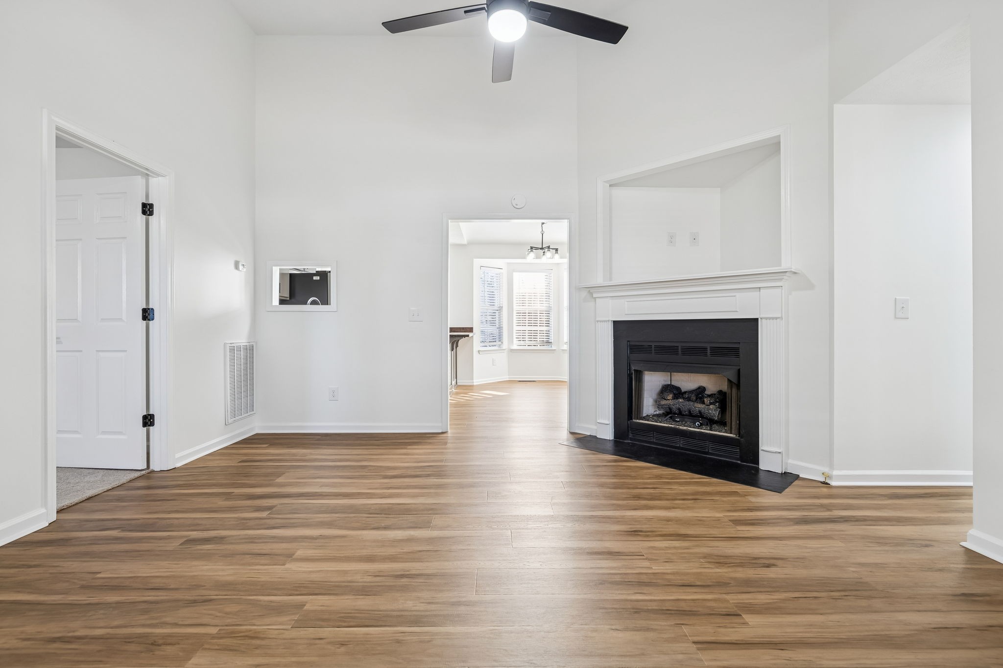803 Pebble Point Mount Juliet, TN 37122 - Photo 7 of 39 a view of an empty room with wooden floor fireplace and a window