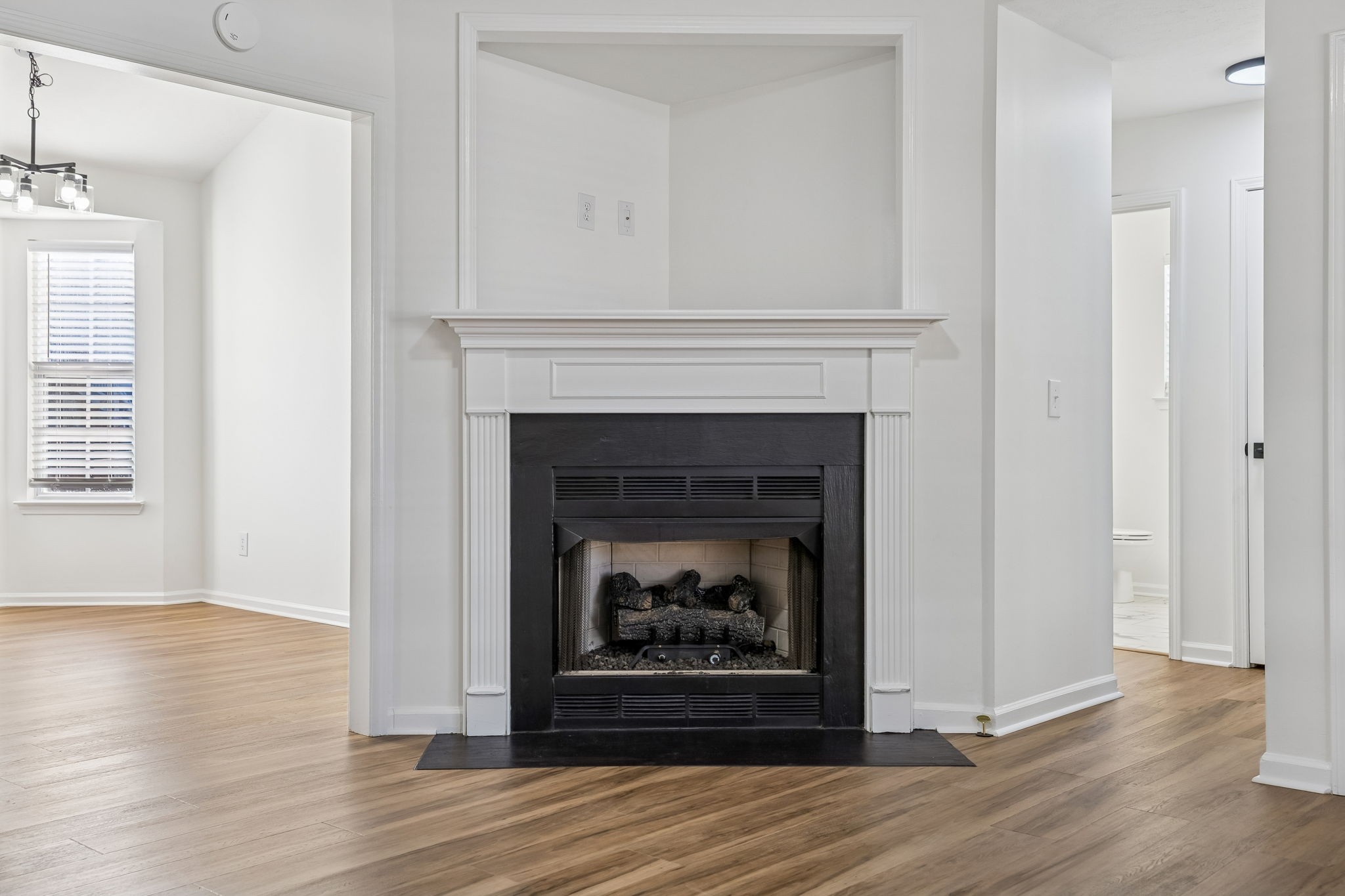 803 Pebble Point Mount Juliet, TN 37122 - Photo 9 of 39 a living room with a fireplace and wooden floor
