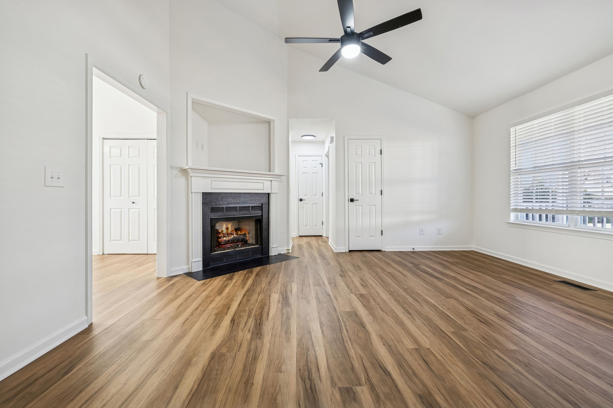 803 Pebble Point Mount Juliet, TN 37122 - Photo 10 of 39 a view of an empty room with wooden floor fireplace and a window