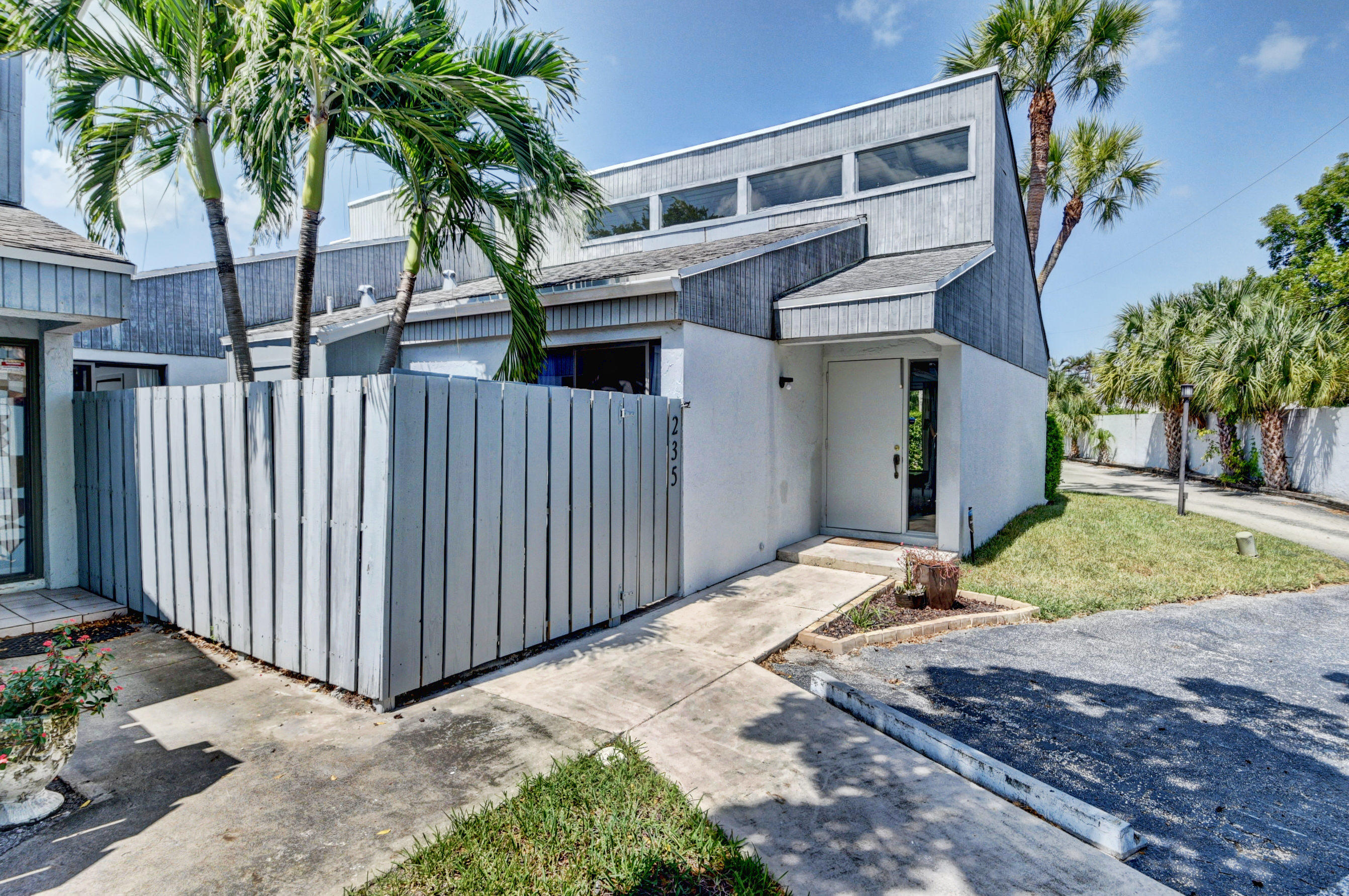 235 Northwest 15th Street Boca Raton, FL 33432 - Photo 2 of 32 a view of a house with a yard and potted plants