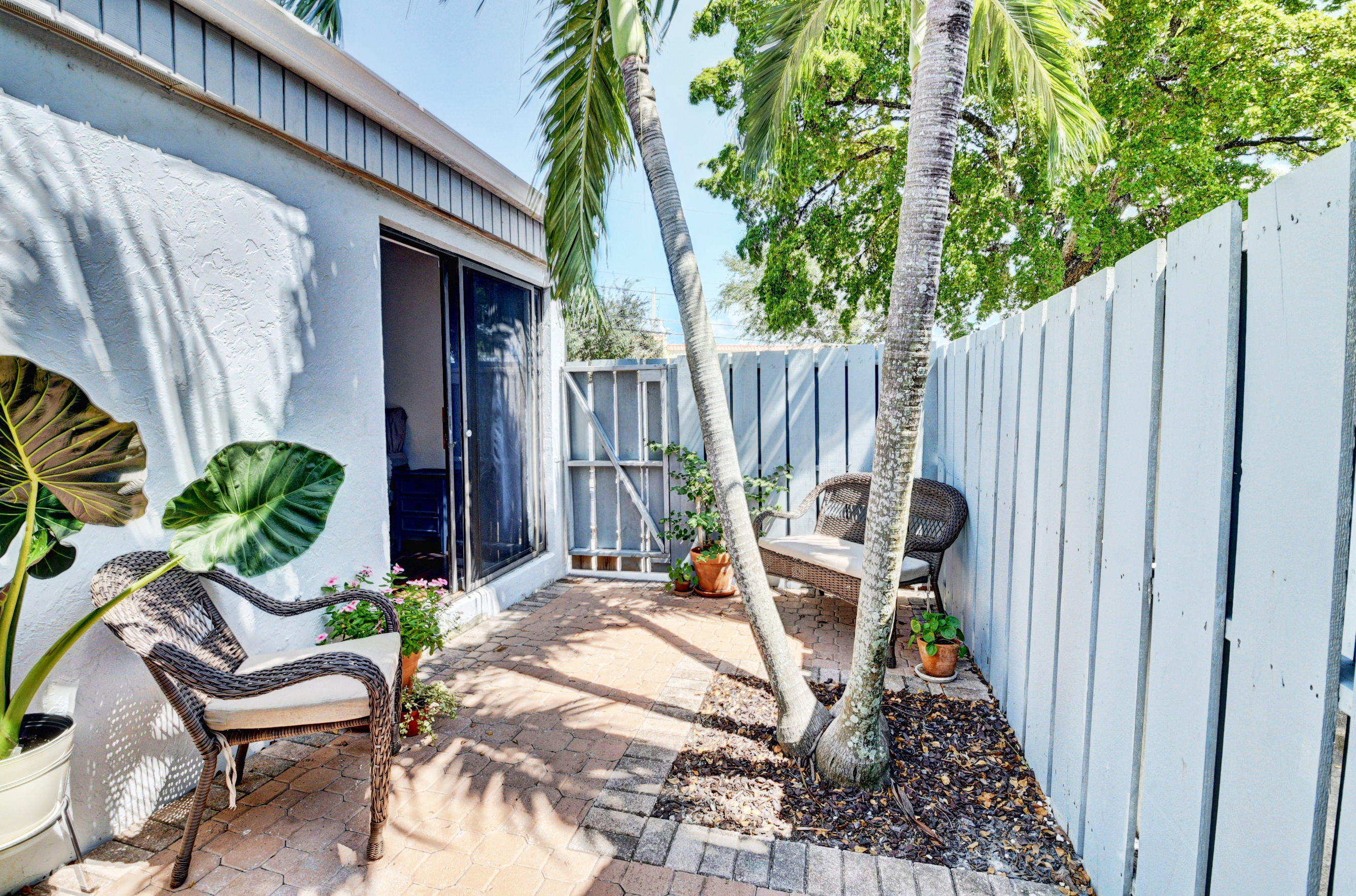 235 Northwest 15th Street Boca Raton, FL 33432 - Photo 26 of 32 a view of a chairs and table in backyard of the house