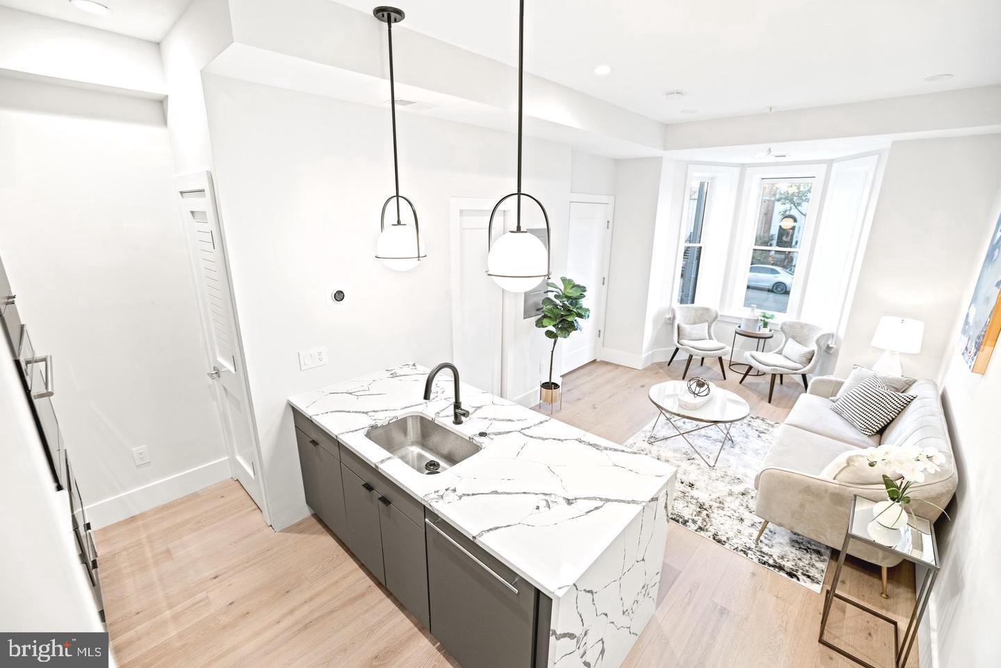 1128 6th Street Northwest, Unit 3 Washington, DC 20001 - Photo 11 of 26 a spacious bathroom with a granite countertop sink and a mirror