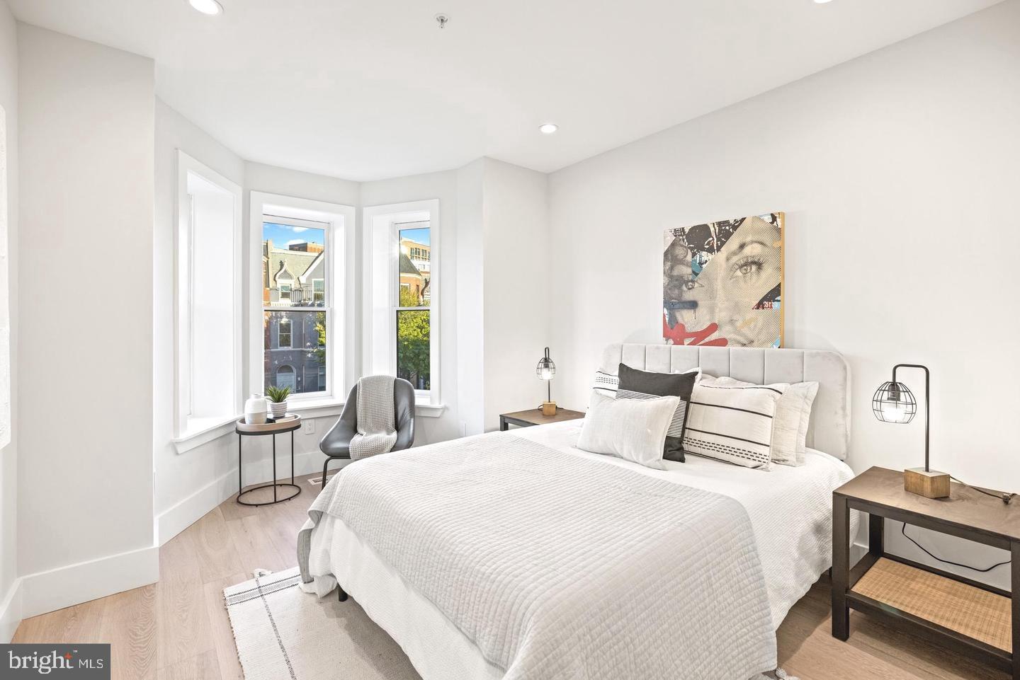 1128 6th Street Northwest, Unit 3 Washington, DC 20001 - Photo 18 of 26 a bedroom with a bed and wooden floor