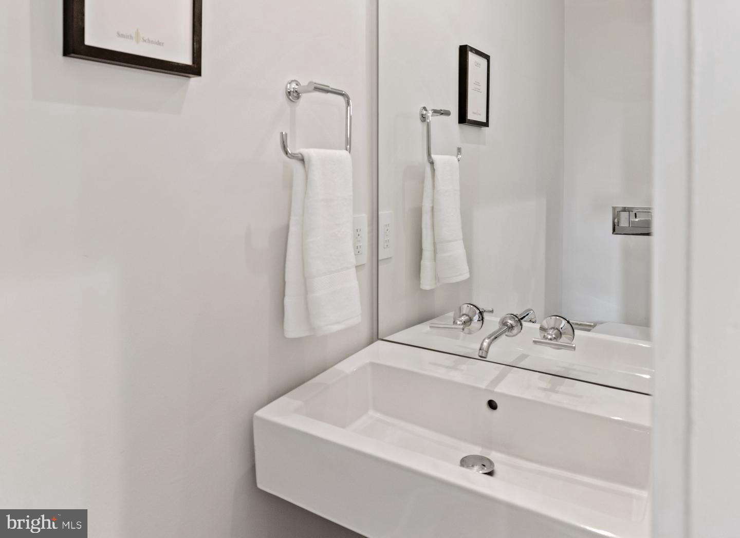 1128 6th Street Northwest, Unit 3 Washington, DC 20001 - Photo 25 of 26 a bathroom with a sink and a mirror