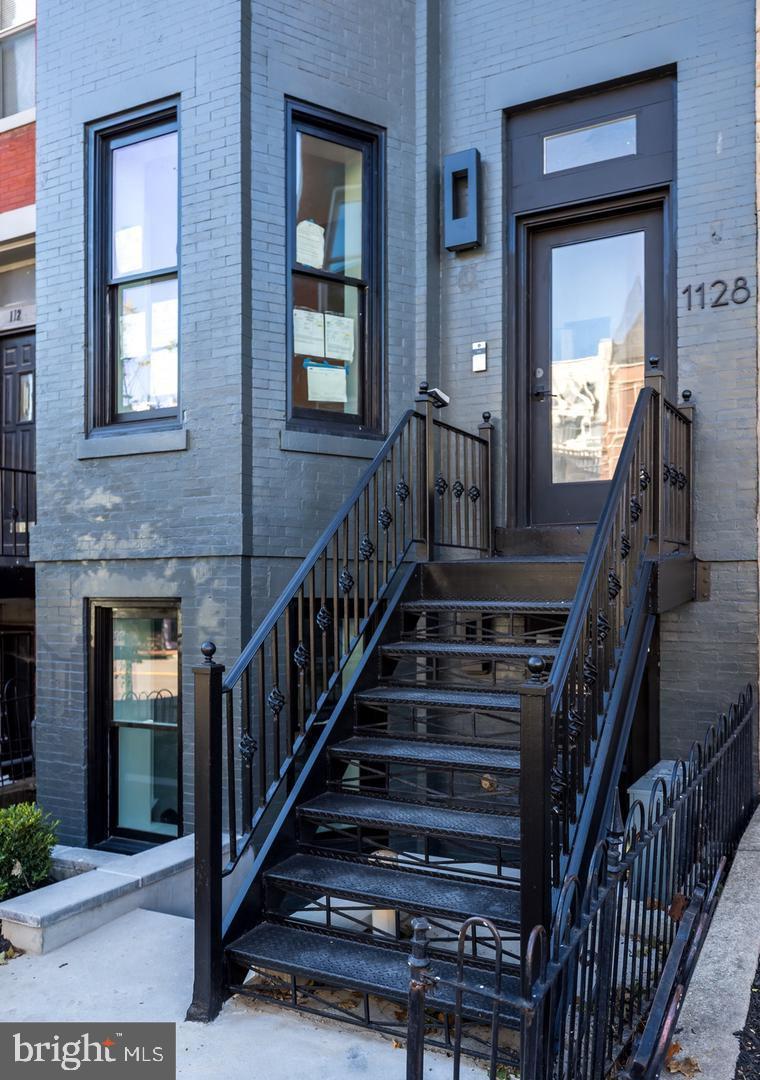1128 6th Street Northwest, Unit 3 Washington, DC 20001 - Photo 4 of 26 a view of staircase with wooden floor and a front door