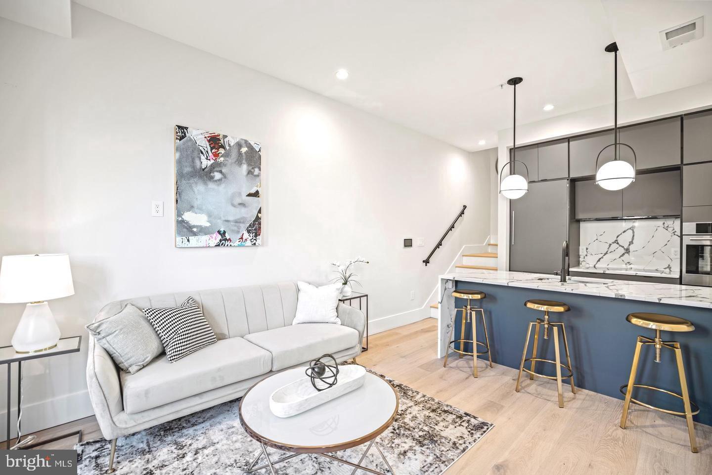 1128 6th Street Northwest, Unit 3 Washington, DC 20001 - Photo 7 of 26 a living room with furniture a rug and kitchen view