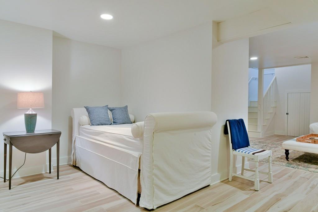 51 Madequecham Valley Road Nantucket, MA 02554 - Photo 19 of 25 a bedroom with a bed and a chair