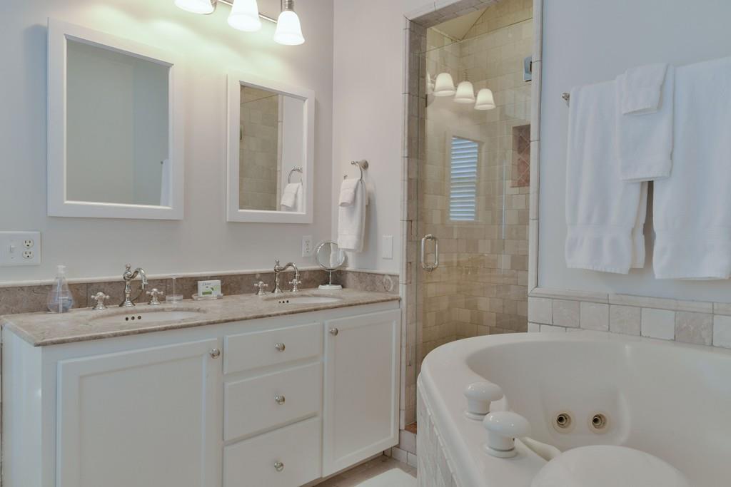 51 Madequecham Valley Road Nantucket, MA 02554 - Photo 21 of 25 a bathroom with a tub sink and mirror