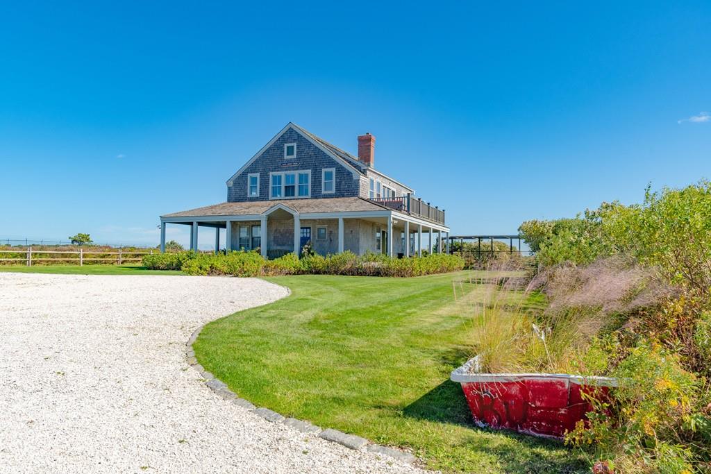 51 Madequecham Valley Road Nantucket, MA 02554 - Photo 3 of 25 a front view of a house with a yard