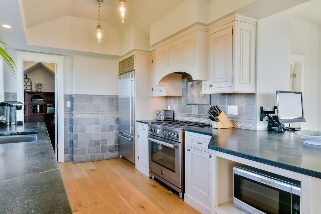 51 Madequecham Valley Road Nantucket, MA 02554 - Photo 9 of 25 a kitchen with stainless steel appliances granite countertop a stove a sink and a refrigerator