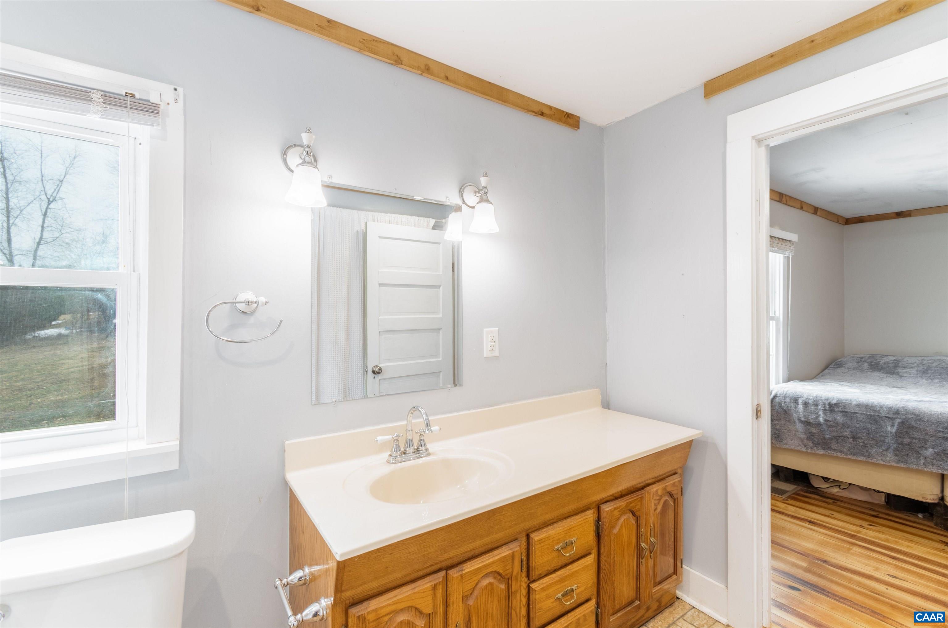 3626 Laurel Road Shipman, VA 22971 - Photo 18 of 36 a en suite bathroom with a granite countertop sink and a mirror