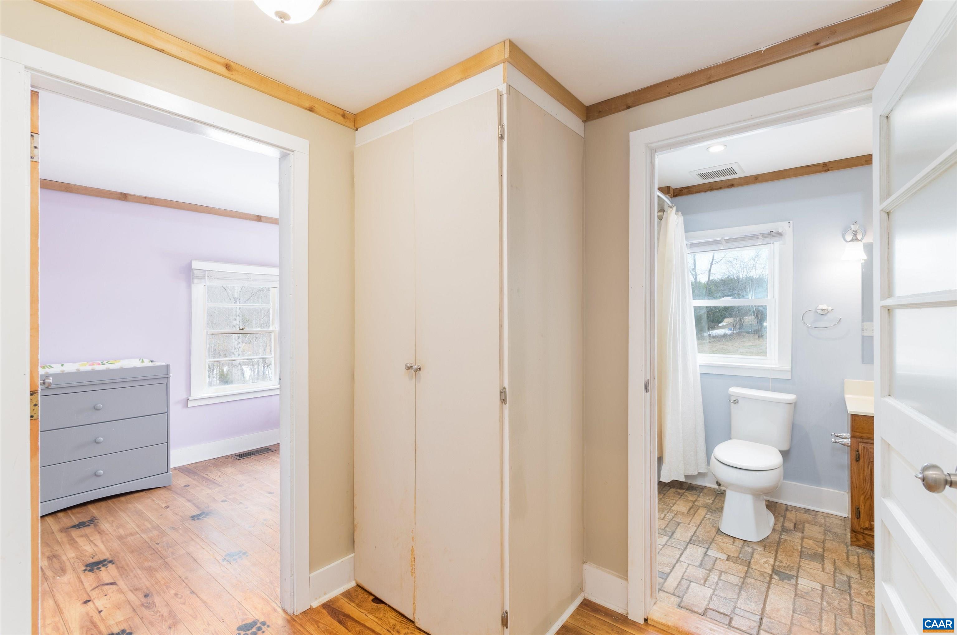 3626 Laurel Road Shipman, VA 22971 - Photo 21 of 36 a bathroom with a granite countertop sink a toilet and a shower