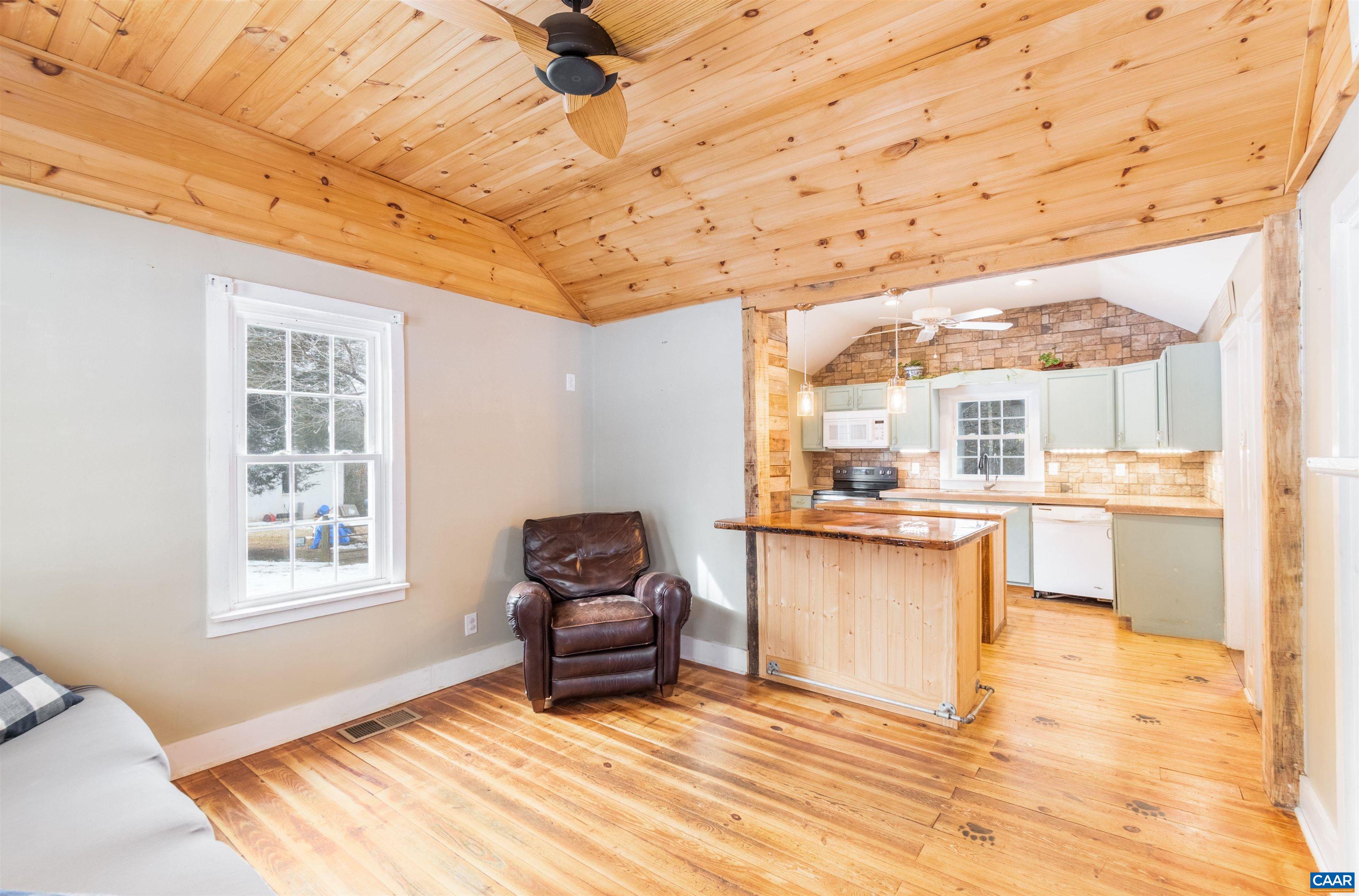 3626 Laurel Road Shipman, VA 22971 - Photo 10 of 36 a living room with stainless steel appliances kitchen island granite countertop furniture and a wooden floor