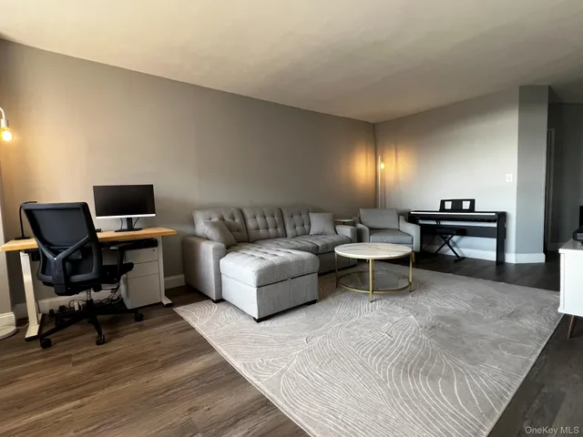 a bedroom with furniture and a wooden floor